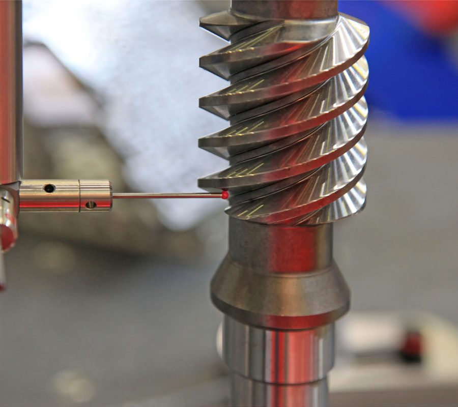 Detail of the tip of a 3d laser scanner mechanical arm, with laser beam scanning a surface.